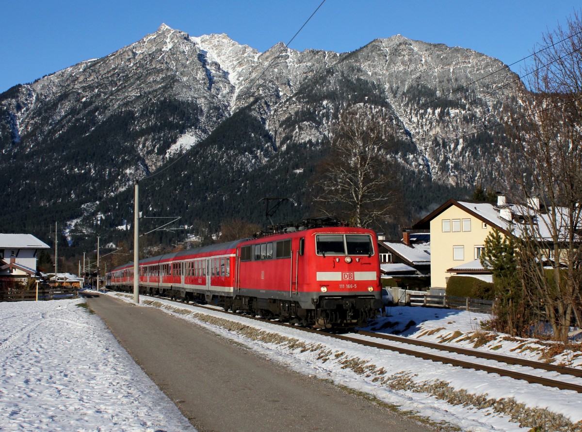 Die 111 166 mit einer RB nach Mittenwald am 08.12.2013 unterwegs bei Garmisch-Partenkirchen.