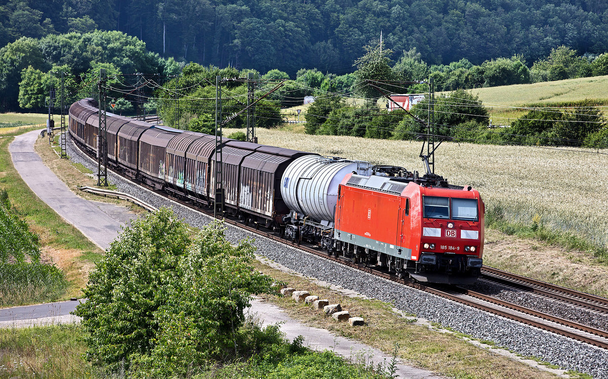 Die 185 184-9 fährt in Gambach mit einem gemischten Güterzug vorbei.Bild vom 16.6.2017