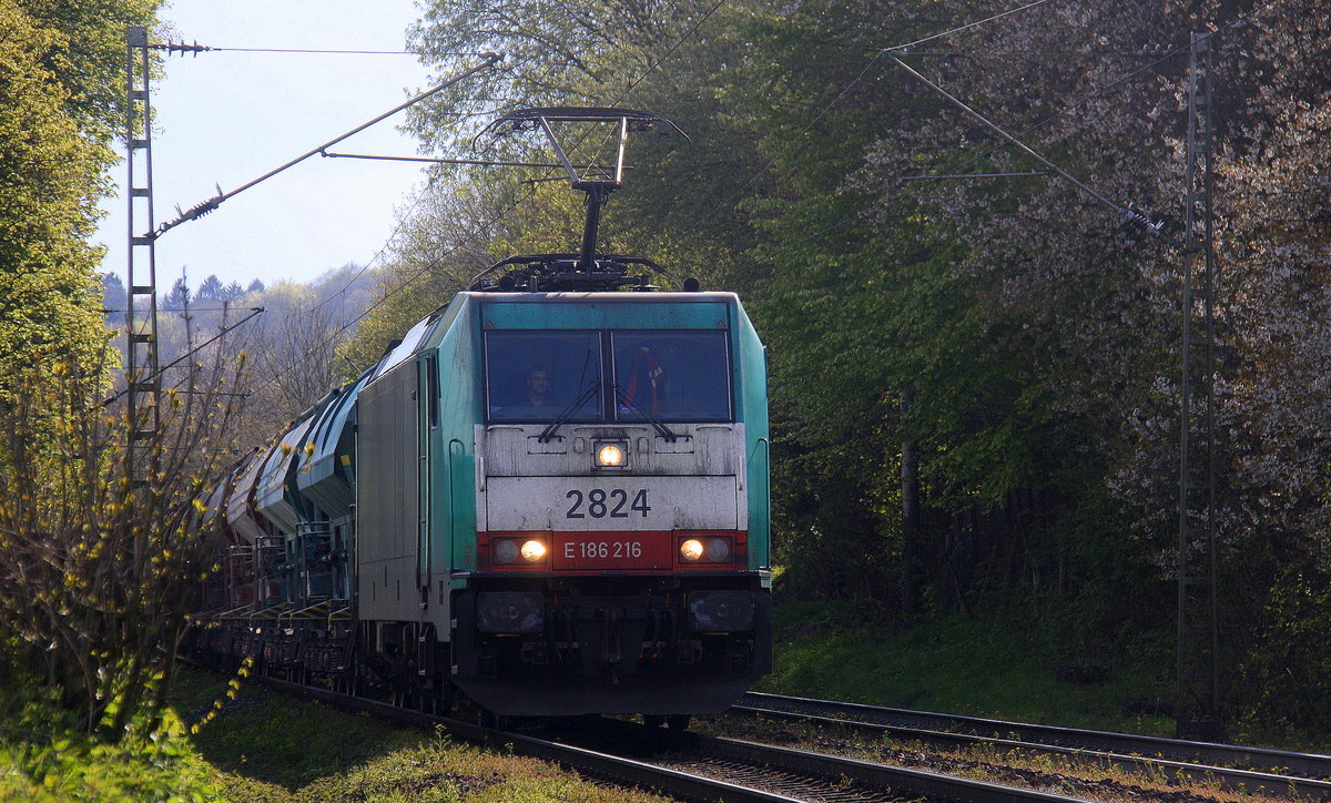 Die Cobra 2824  kommt die Gemmenicher-Rampe herunter nach Aachen-West mit einem langen Kalkzug aus Marche-les-Dames(B) nach Hagen(D).
Aufgenommen an der Gemmenicher-Rampe am Gemmenicher-Weg an der Montzenroute. 
Bei Sonne und Regenwolken am Nachmittag vom 28.4.2016.