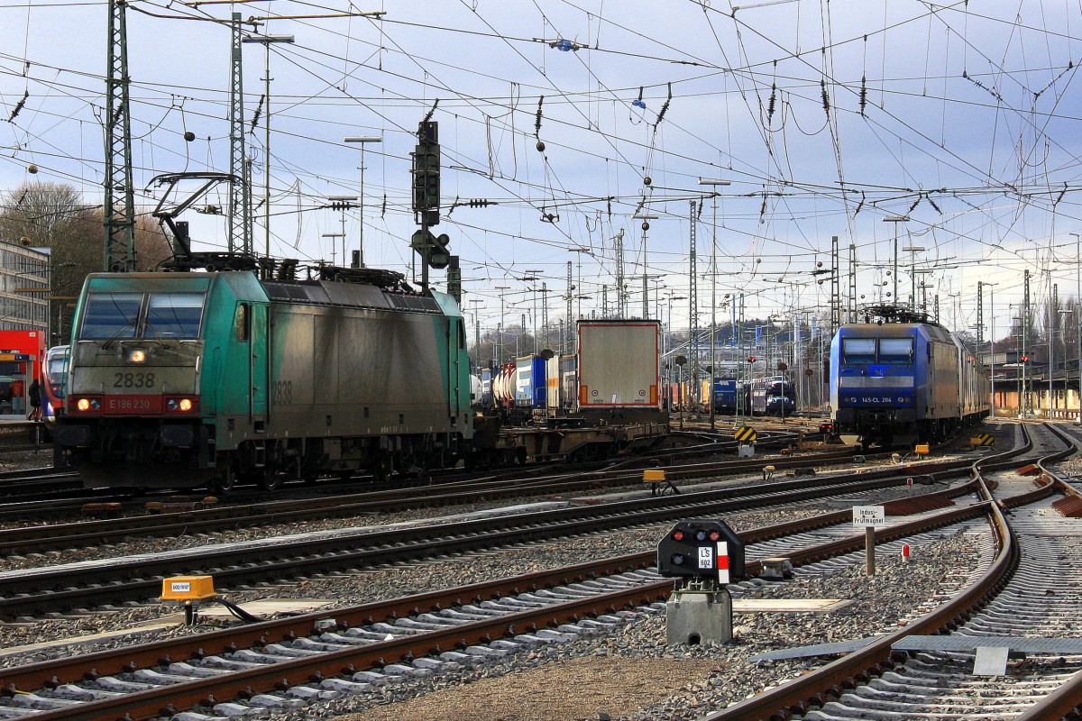 Die Cobra 2838 fährt mit einem langen Containerzug aus Gallarate(I) nach Antwerpen-Oorderen(B) bei der Ausfahrt aus Aachen-West und fährt in Richtung Montzen/Belgien
und auf dem Nebengleis eine 145 CL-204 von Crossrail steht mit 8 E-Loks von Crossrail stehen auf dem abstellgleis in Aachen-West bei Sonne und Regenwolken am Nachmittag vom 16.2.2014. 