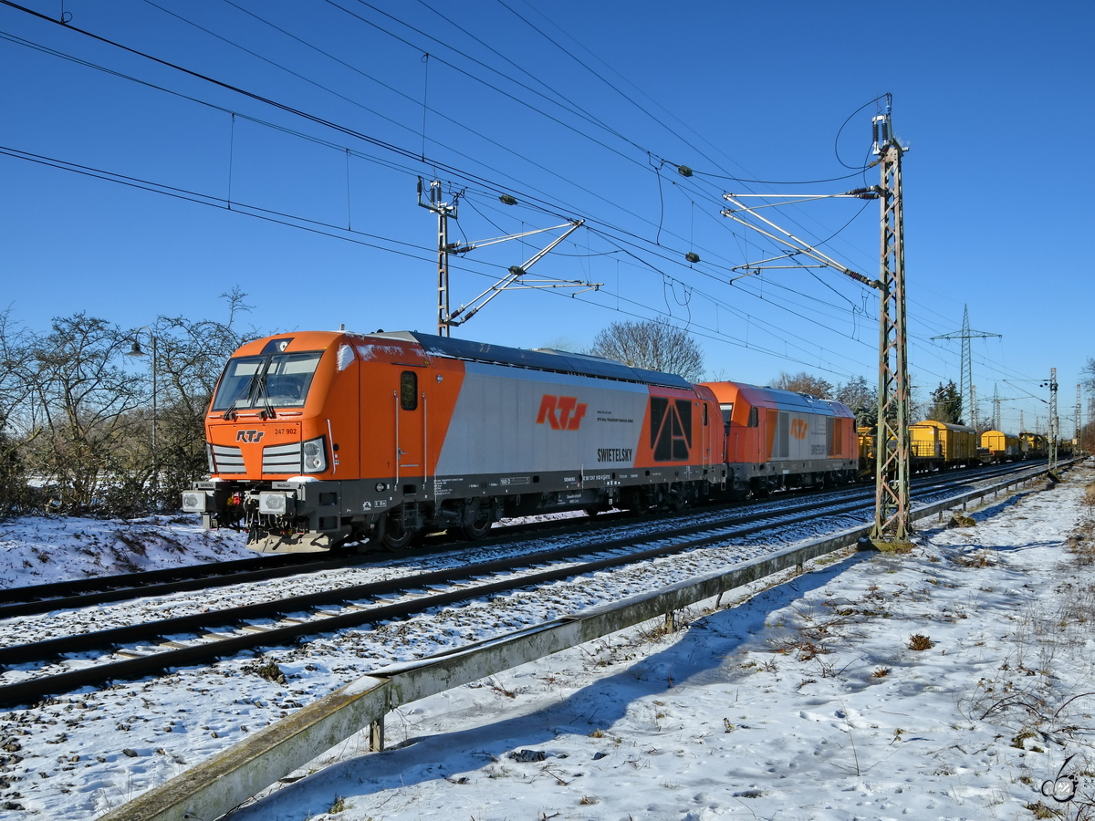 Die Diesellokomotiven 247 902 & 2016 907 ziehen einen langen Bauzug, so gesehen im Februar 2021 in Lintorf.