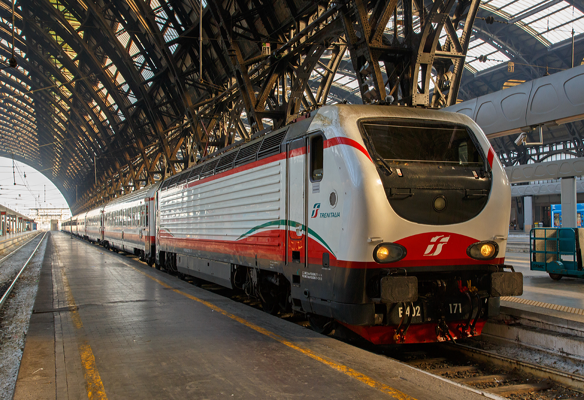 Die E.402.171 (91 83 2402 171-9 I-TI) der Trenitalia (100-prozentige Tochtergesellschaft der Ferrovie dello Stato) ist am 29.12.2015 mit einem Frecciabianca (deutsch: weißer Pfeil) in den Bahnhof Milano Centrale (Mailand Zentral) eingefahren. Der Frecciabianca ist eine Zuggattung für Züge (IC) mit einer Höchstgeschwindigkeit von 200 km/h.

Die FS E.402B ist eine Weiterentwicklung der E.402A, verfügt jedoch gegenüber ihrem Vorgängermodell zum Beispiel über ein höheres Gewicht sowie einen neu gestalteten und futuristischeren Wagenkasten. Die Höchstgeschwindigkeit ist jedoch mit 200 km/h etwas geringer als bei der E.402A (mit 220 km/h). Von den Lok wurden 80 Stück zwischen 1997 und 2000 von AnsaldoBreda und Sofer gebaut.

Die Baureihe E.402B ist eine Mehrstromlokomotive, sie kann unter 3000 V Gleichstromspannung, dem hauptsächlichen italienischen Bahnnetz, aber auch auf den italienischen Schnellfahrstrecken mit 25 kV, 50 Hz Wechselstrom fahren. Fernerhin kann sie unter 1500 V Gleichstrom betrieben werden, dann hat sie aber nur die halbe Leistung. 

Die Lok ist eine vollelektronische Chopperlokomotive, das heißt, wenn die Lokomotiven unter 3000 V DC fährt, wird der Strom mit Hilfe eines Zerhackers in Wechselstrom umändern, der dann schließlich die Motoren antreibt. 

Technische Daten:
Spurweite:  1435 mm (Normalspur)
Achsformel: Bo'Bo'
Länge: 19.420 mm
Drehzapfenabstand: 10.450 mm
Achsabstand im Drehgestell: 2.850 mm
Dienstgewicht: 89 t
Höchstgeschwindigkeit: 200 km/h
Stundenleistung: 6.000 kW
Dauerleistung: 5.600 kW
Anfahrzugkraft: 280 kN
Treibraddurchmesser:  1.250 mm
Stromsysteme: 3000 V DC, 25 kV - 50 Hz AC und 1500 V DC (bei halber Leistung)
