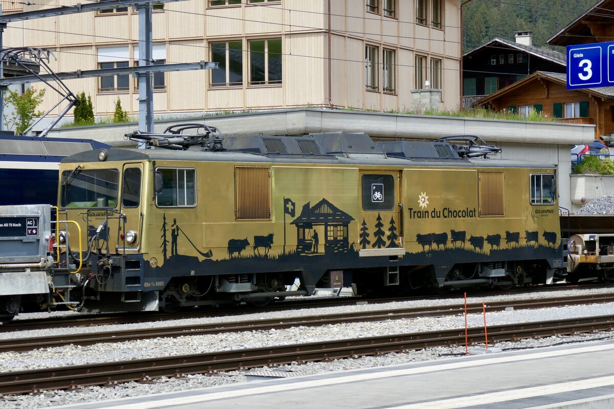 Die GDe 4/4 6003 der MOB mit Werbung Train du Chocolat am 19.5.23 im Bahnhof Zweisimmen abgestellt.