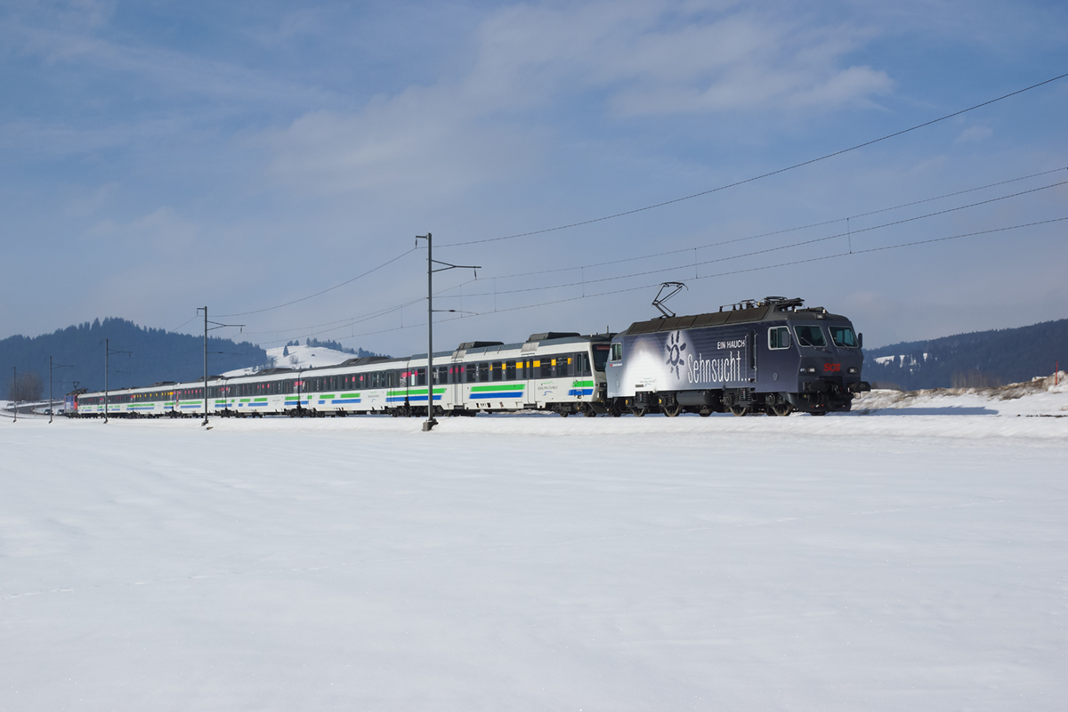 Die Neue: Re 446 017-6 mit Eigenwerbung für den Voralpen-Express ( Ein Hauch Fernweh/Ein Hauch Sehnsucht ) nähert sich am 15.02.2015 Biberbrugg.