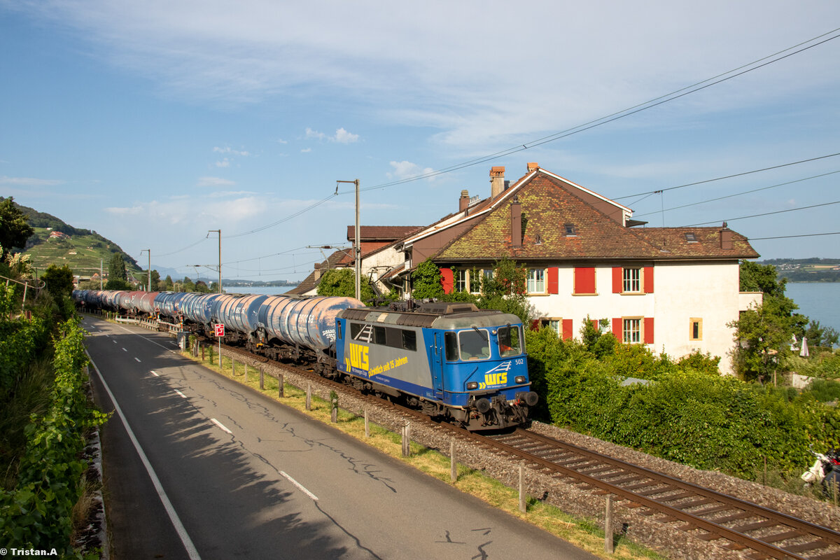 Die Re 420 502 von WRS (ex BLS) fährt mit einem Kesselzug aus Basel durch Ligerz Richtung Renens. 7.7.2023