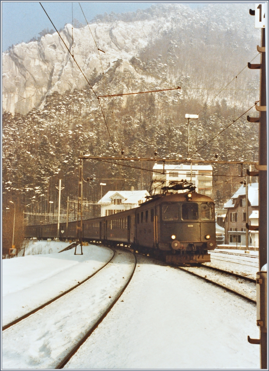 Die Re 4/4 I 10039 verlässt mit ihrem Schnellzug von Basel SBB nach  Biel/Bienne am 17. Januar 1985 die enge Schlucht von Moutier und trifft im Bahnhof von Moutier ein.
(Gescanntes Foto)
