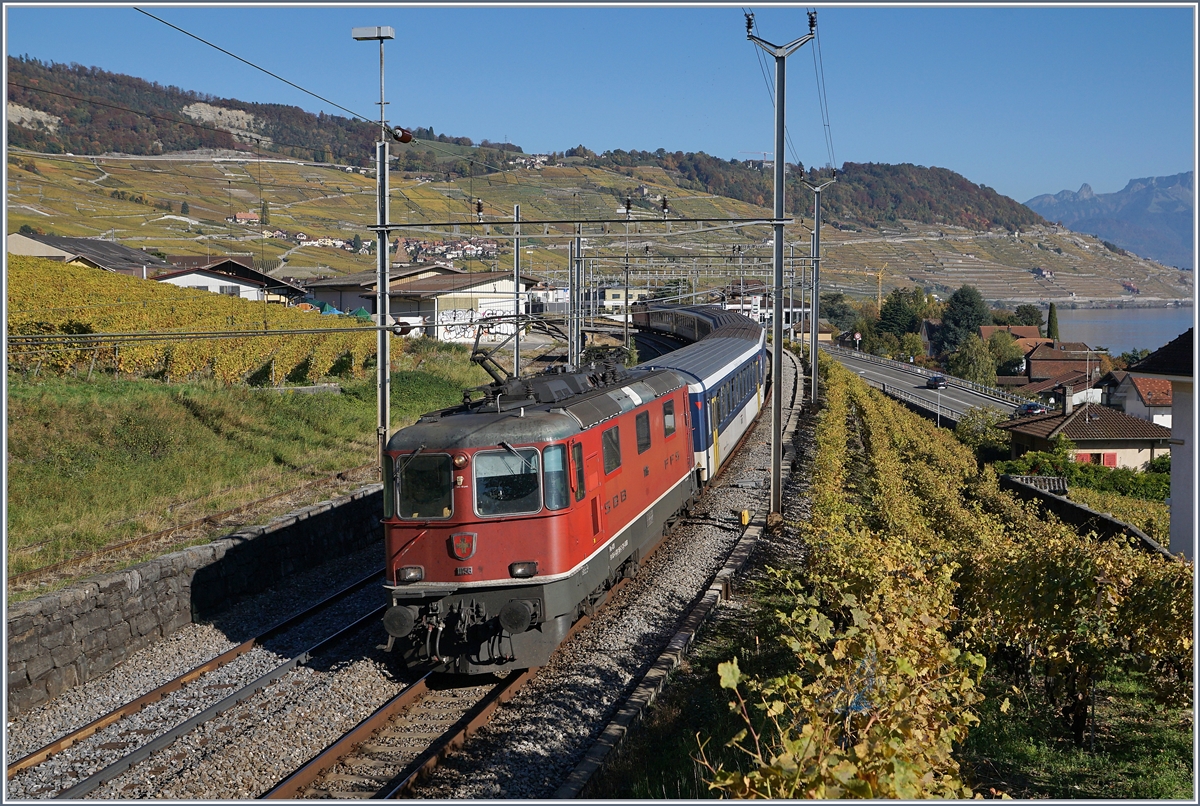 Die SBB Re 4/4 II 11158 (und am Zugsschluss eine weitere Re 4/4 II) mit einem Dispozug in Richtung Lausanne bei der Ausfahrt in Cully.

16. Okt. 2017