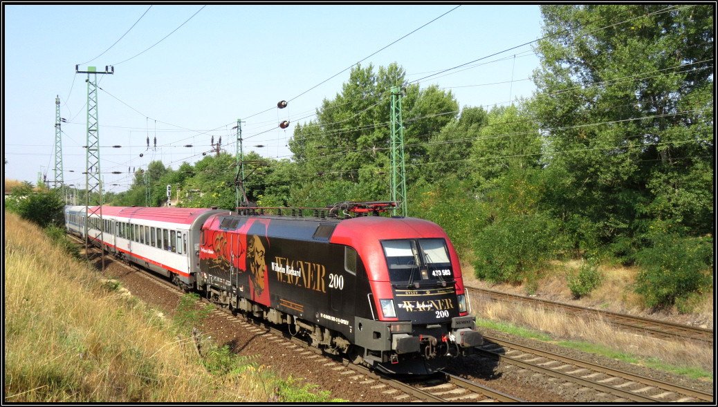 Die Taurus Lok 470 503 im Wagner Design ist hier mit einen EC aus Wien unterwegs nach Budapest. Gerade erreicht der Zug den Stadtrand von Komárom am 06.August 2015.