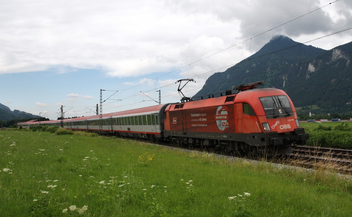 Die Werbelok 1116 143-8``Charly``RCA Montan der ÖBB ist am 24.6.2014 mit dem EC München-Verona durch das Inntal unterwegs. Hier kurz vorm BÜ in Niederaudorf.