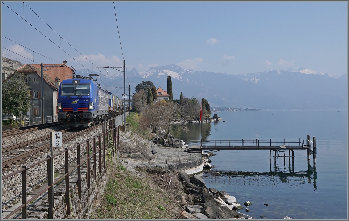 Die WRS Re 475 902 fährt mit einem Kesselwagenzug Richtung Lausanne bei St-Saphorin am Genfer See entlang. Das Bild entstand auf dem Bahnsteig von St-Saphorin.  

25. März 2022