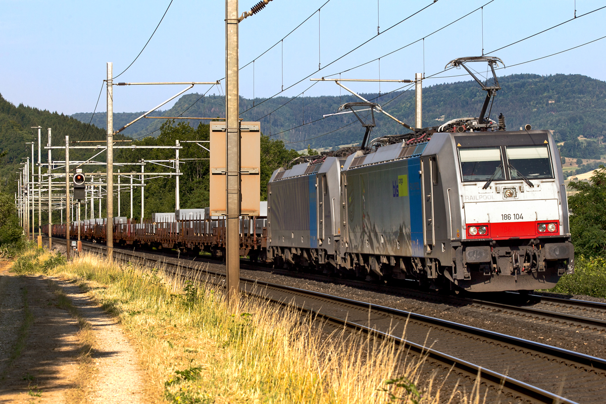 Doppeltraktion 186 104 und 186 102 fahren in Frick mit einem Aluminiumzug vorüber.Bild vom 15.7.2015