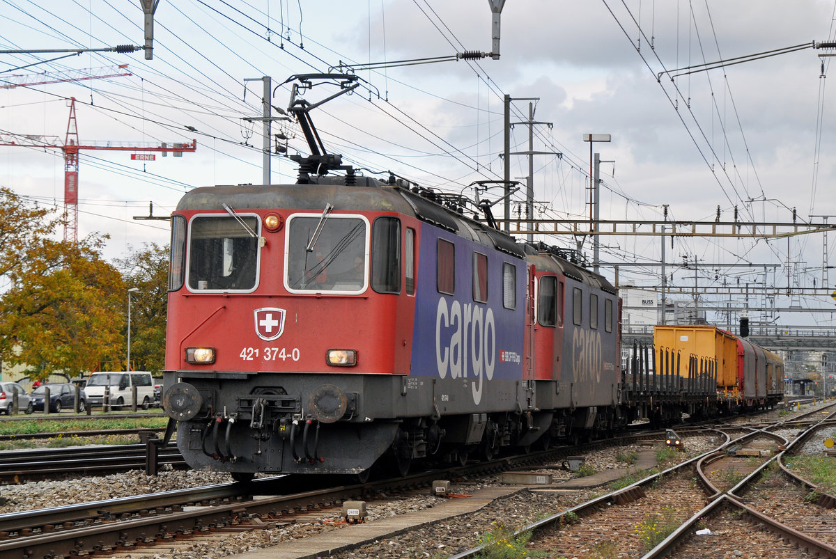 Doppeltraktion, mit den Loks 421 374-0 und 421 393-0, durchfahren den Bahnhof Pratteln. Das abzweigende Gleis führt auf eine Strasse und in ein Industriegebiet, von wo aus auch diese Aufnahme am 20.10.2016 entstand. 