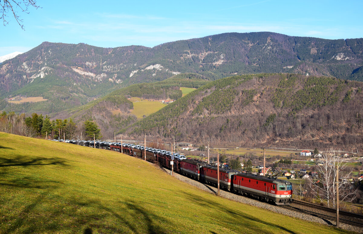 Dreifachtraktion 1144 mit einem Škoda-Autozug am Semmering in Richtung Süden.
Eicberg, 29.12.2022.