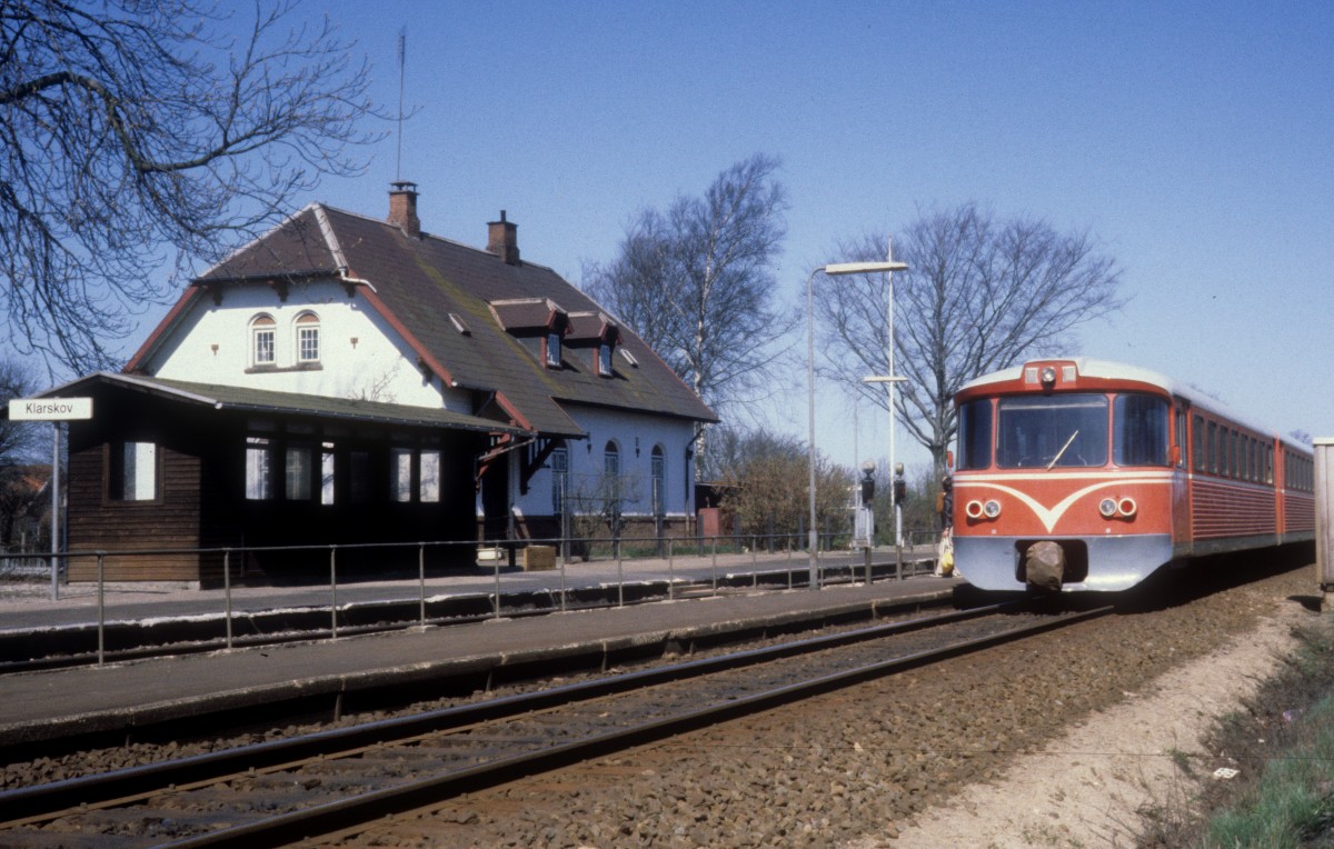 DSB-Kleinstadtbahnhöfe: Der ehemalige Bahnhof Klarskov am 14. April 1981. Am Bahnsteig hält ein Triebzug des Unternehmens Lollandsbanen.- Der Bahnhof wurde 1968 zu einem Haltepunkt umgestaltet. 1982 wurde der Haltepunkt geschlossen. - Das Bahnhofsgebäude wurde 1906 von Heinrich Wenck, dem Chefarchitekten der DSB, entworfen. Heinrich Wenck, der von 1851 bis 1936 lebte, entwarf mehr als 300 Gebäude , u.a. den Kopenhagener Hauptbahnhof und den Bahnhof Helsingør samt den kleinen Bahnhöfen in Herfølge und Lille Skensved.