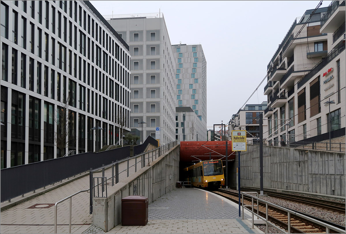 Durch das neue Stuttgart - 

Im neuen dicht bebauten Europaviertel kommt eine Bahn der Linie U12 nach Remseck ans Tageslicht. Im Bereich der Rampe befindet sich eine für die Oldtimerstraßenbahnlinie 23 angelegte Haltestelle für die Fahrtrichtung Bad Cannstatt. Bei Gelegenheit kann ich da mal eine Straßenbahn fotografieren, also an einer Stelle an der früher nie Straßenbahnen fuhren.

01.02.2022 (M)