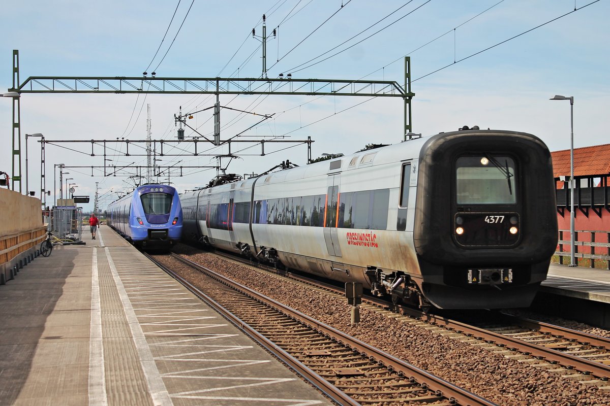 Durchfahrt am Vormittag des 17.07.2019 von X31K 4377 zusammen mit X31K 4394 als Øresundtåg durch den Haltepunkt von Hjärup in Richtung Lund, als am anderen Bahnsteoig der Skånetrafiken X61070 zusammen mit Skånetrafiken X61060 als Pågatågen standen.