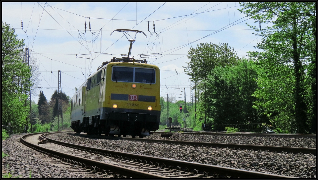 Dynamisch legt sich die 111 059-2 mit einen Messzug in den Gleisbogen bei Eschweiler auf der Kbs 480. So gesehen am 05.Mai 2015 vom Parkplatz aus.