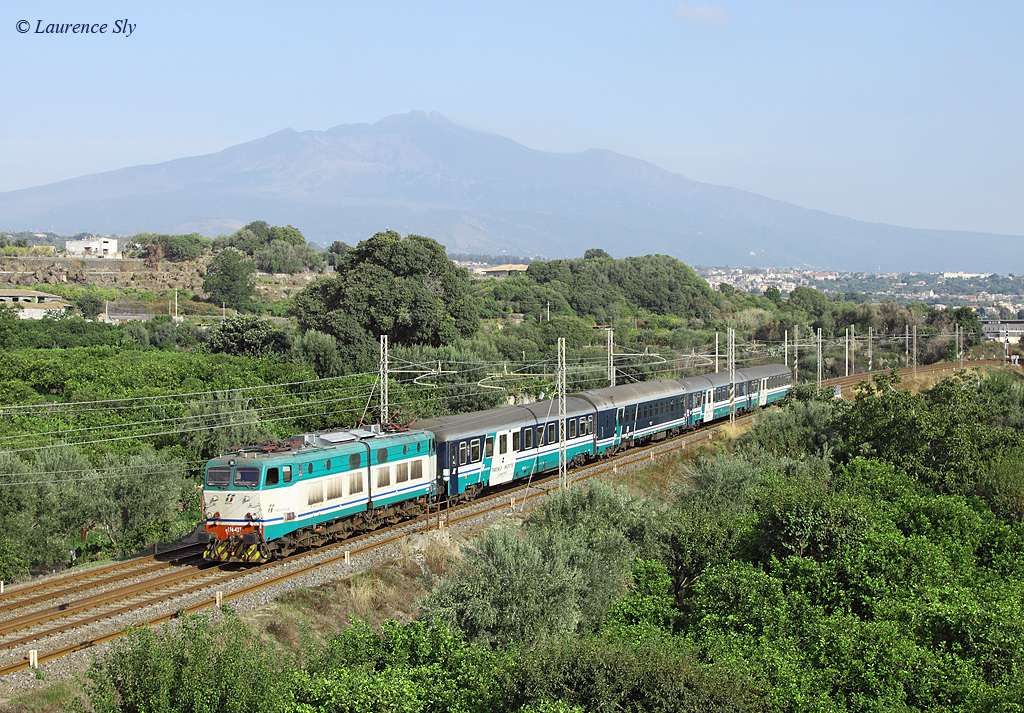E.656 427 departs Acireale whilst working IC1959, 2220 Roma Termini-Siracusa, 11 Sept 2013.

In the background is Mount Etna.