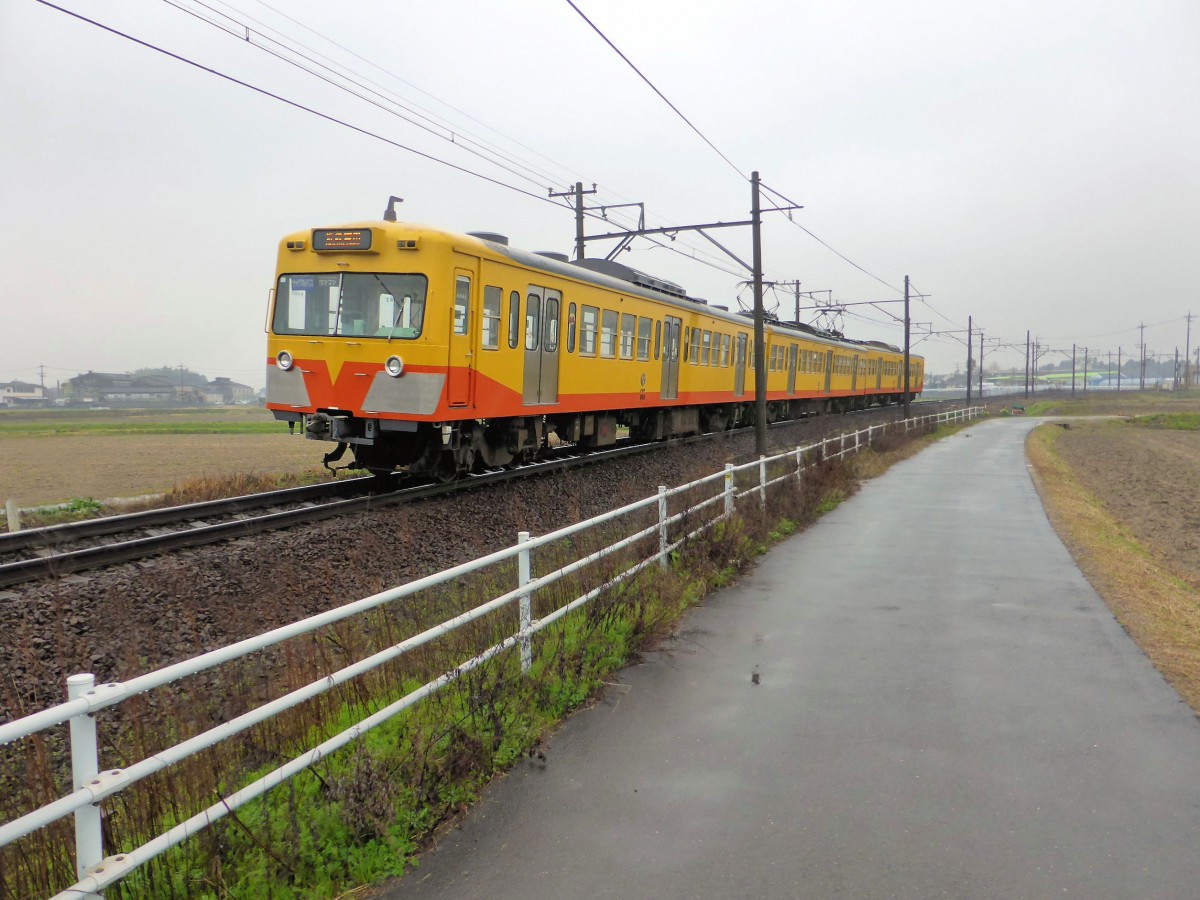 Ein ehemaliger Seibu-Zug. Die kleinen elektrischen Privatbahnen überall in Japan erneuern sich im wesentlichen mit ausgemusterten S-Bahnfahrzeugen aus Tokyo. So auch die westlich der Stadt Nagoya an der Ise-Bucht in Zentraljapan verkehrende Sangi-Bahn. Im Bild die deutlich als einstiger Seibu-Zug zu erkennende Komposition 851 der Sangi-Bahn, im regnerisch-trüben Hobo, 26.März 2014. Zug 851 besteht aus den beiden Motorwagen des einstigen Seibu-Vierwagenzugs 789 (Serie 700, Baujahre 1963-1967); dem einen Motorwagen hat man den Führerstand eines der abgebrochenen Steuerwagen aufgepfropft. Hinten ist neuer Steuerwagen angefügt, der von einem ausgemusterten Seibu-Zug Serie 101 stammt (Baujahre 1980-1982).  