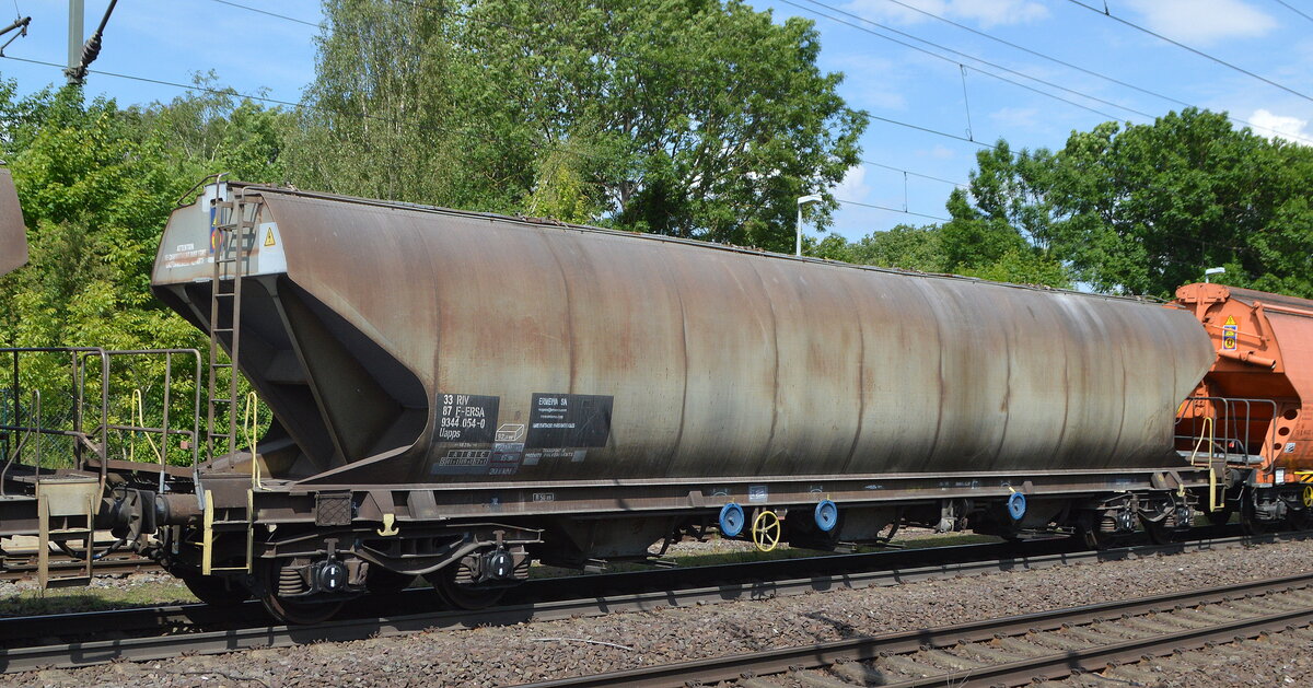 Ein französischer etwas längerer schmaler Drehgestell-Schüttgutwagen mit dosierbarer Schwerkraftentladung für Getreide vom Einsteller ERMEWA SA mit der Nr. 33 RIV 87 F-ERSA 9344 054-0  Uapps in einem Getreidezug am 01.06.22 Höhe Bf. Niederndodeleben (Nähe Magdeburg).