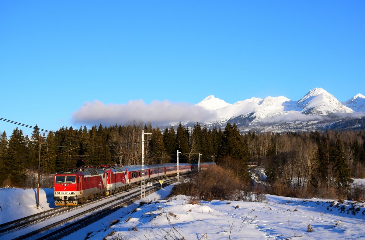 Ein interessanter Morgenzug am Fuße der Tatra: die 162 001 und 362 001 sind mit dem Zug R16767 zwischen Štrba und Štrba Zastávka.
20.01.2024.