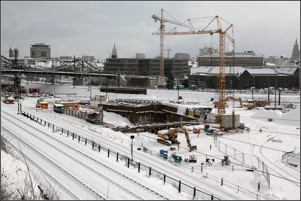 Ein Kran für die Straßenbahn Ulm, ein Kran für die NBS Stuttgart Ulm -

In der Baugrube in Bildmitte befindet sich das Tunnelportal des Albabstiegtunnels der Neubaustrecke Stuttgart Ulm, darüber in Bildmitte der Bau des Widerlagers für die Straßenbahnbrücke der zukünftigen Linie 2. Diese Brücke wird das Bahngelände schräg queren und in etwa auf meinen Standort zulaufen. Die Linie 2 wird dann einmal den Kuhberg mit dem Eselsberg verbinden. Es ist sehr erfreulich, dass die Ulmer Straßenbahn eine zweite Linie bekommt.

17.01.2016 (M)