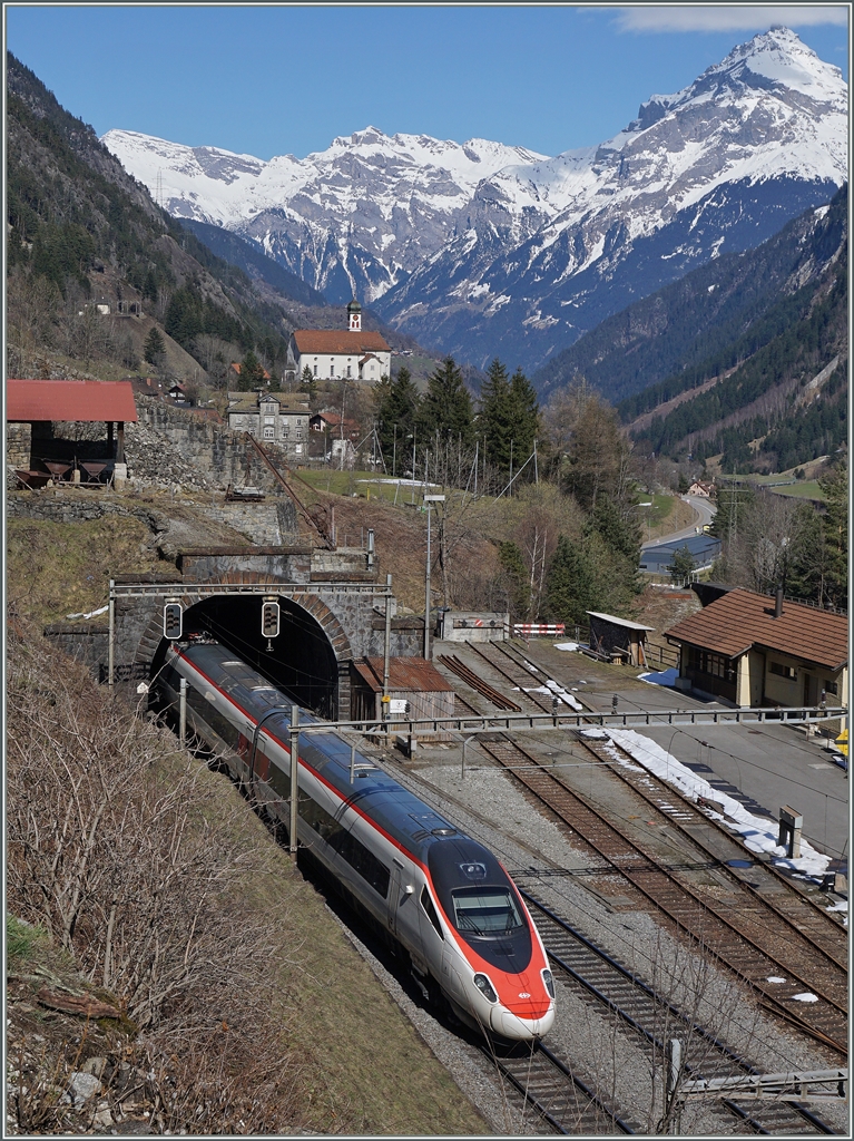 Ein SBB ETR 610 auf der Fahrt Richtung  Süden verschwindet bei der Station Wassen in einen Tunnel, im Hintergrund das legendäre  Chilelii  von Wassen, auf dessen Blick der eilige Reisend Richtung Süden heute verzichten muss.
17. März 2016