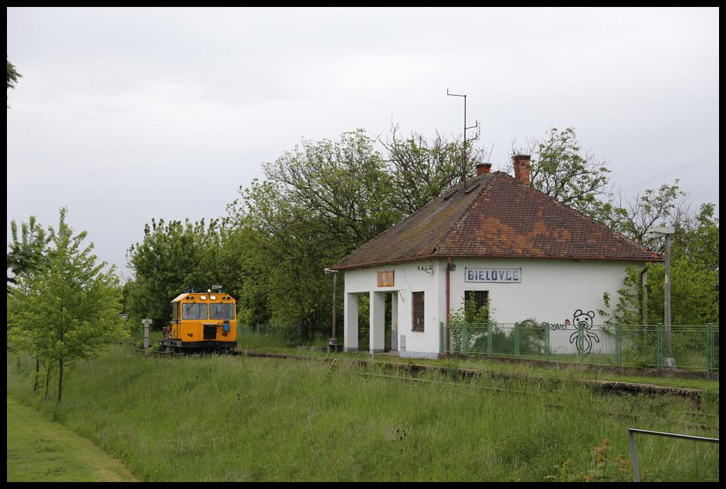 Ein Schienenkleinwagen befuhr am 15.5.2019 die Nebenstrecke in Bielovce. Am dortigen Haltepunkt musste die Besatzung zunächst den Bahnübergang schalten. Das gab mir Gelegenheit, vom BÜ aus die Szene im Bild fest zu halten.