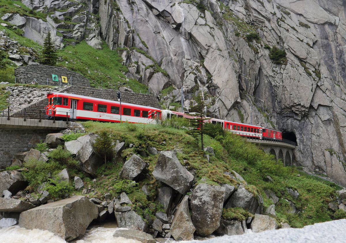 Ein typischer Pendelzug Andermatt - Göschenen mit Abt und Deh 4/4 hat in der Schöllenenschlucht die Reuss überquert und fährt jetzt in den Tunnel vor Göschenen; 12.06.2019
