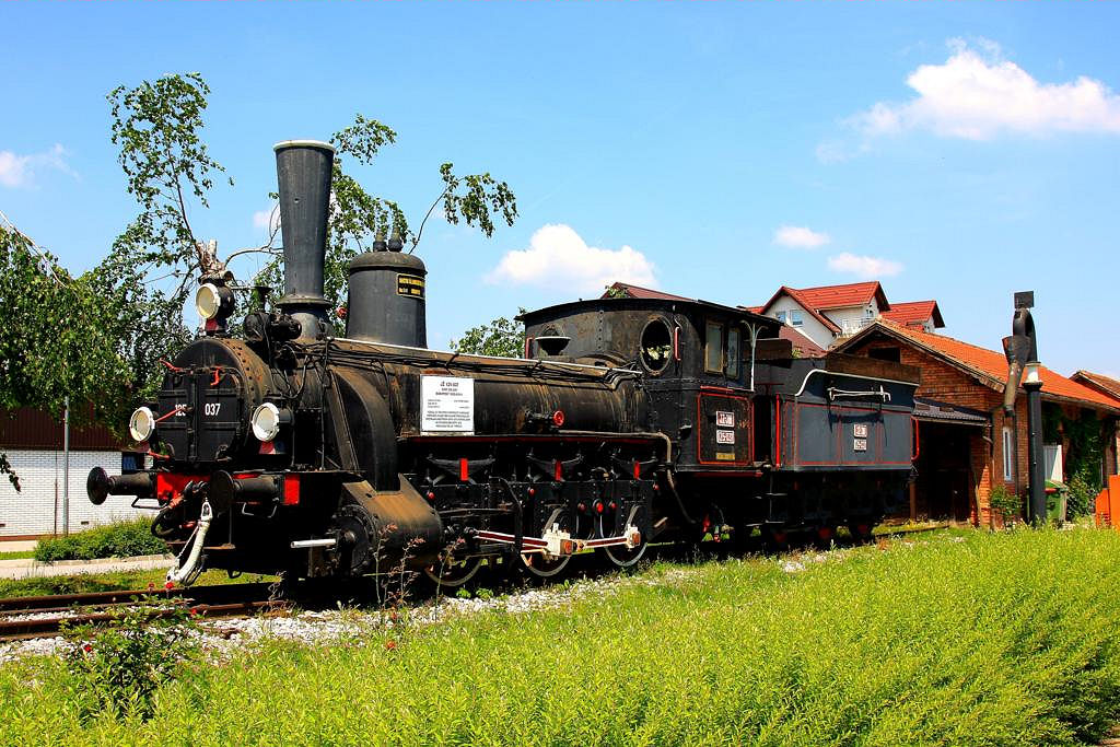 Eine alte Dampflok aus der Zeit der K&K Monarchie steht am Bahnhof Pragersko
in Slowenien. Die Lok wurde 1893 in Budapest gebaut und trägt als letzte Nummer die Bezeichnung der JZ 125-037 der JZ. Die Lok wurde von mir am  19.5.2011 abgelichtet.