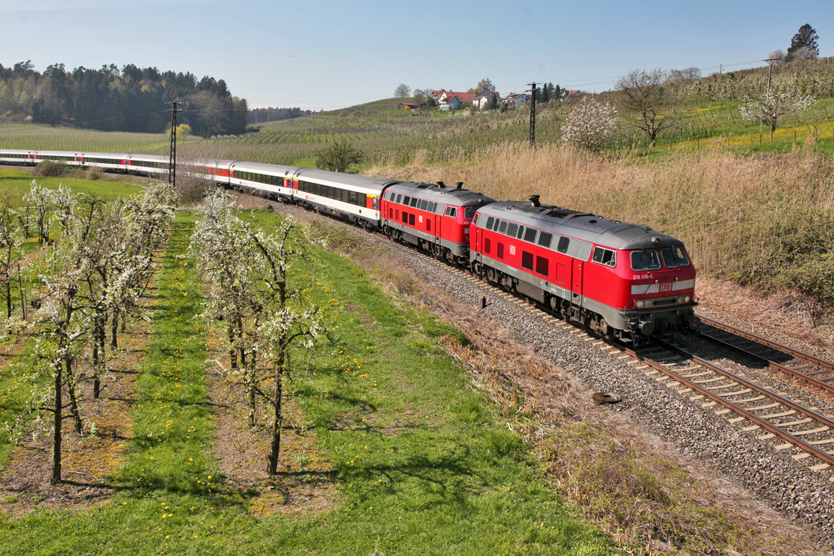 Eine Doppeltraktion der Dieselloks 218 418-6 und der 218 463-8 dieselt in mit einem EC aus Zürich HB nach München Hbf in Oberrreitnau vorüber.Bild vom 11.4.2016