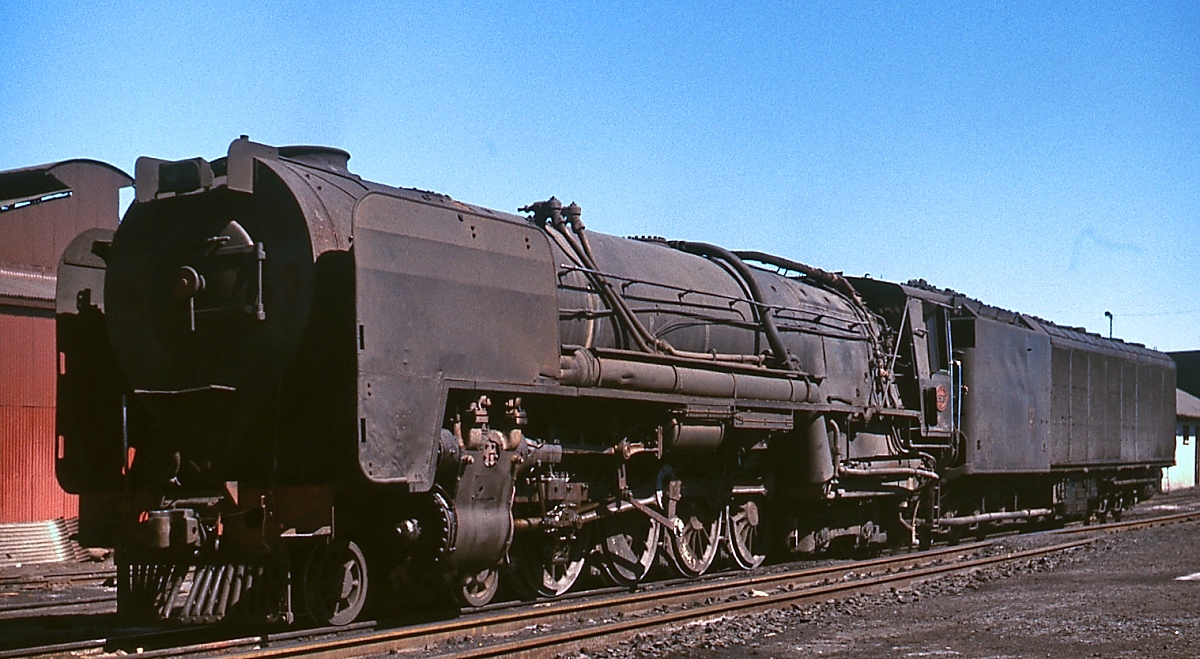 Eine Kondenslokomotive der Reihe 25 (Achsfolge 2'D2') im Depot Kimberley (November 1976). Die Lokomotiven wurden für die Strecken durch die wasserarme Karoo von Henschel und North British 1953/54 gebaut. Beim Anblick dieser gewaltigen Maschinen (Gesamtachsstand Lok und Tender 29.000 mm, indizierte Leistung ca. 3.400 PS) vergaß man, dass sich um Lokomotiven auf Kapspur (= 1.067 mm) handelt. Leider waren zu diesem Zeitpunkt nur noch wenige Maschinen vorhanden, die meisten waren bereits zu 25NC (= non condens) umgebaut.