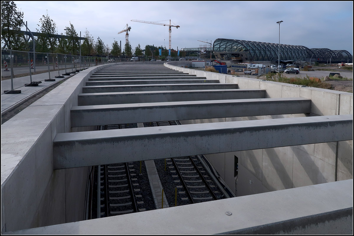 Eine neue Strecke für die Hamburger U-Bahn -

Im Dezember 2018 soll die Linie U4 von der Hafencity Universität nach Westen bis zur Station Elbbrücken verlängert werden. Über eine Rampe kommt die U4 an die Oberfläche zur oberirdischen Endstation. Dort wird dann später auch zur S-Bahn umgestiegen werden können. Diese wird man über die links neben der U-Bahn-Bahnsteighalle erkennbaren gläsernen Steg (Skywalk) erreichen können. Neben der wichtigen Umsteigebeziehung wird die Station auch die bis hierher wachsende Hafencity erschließen.

15.08.2018 (M)