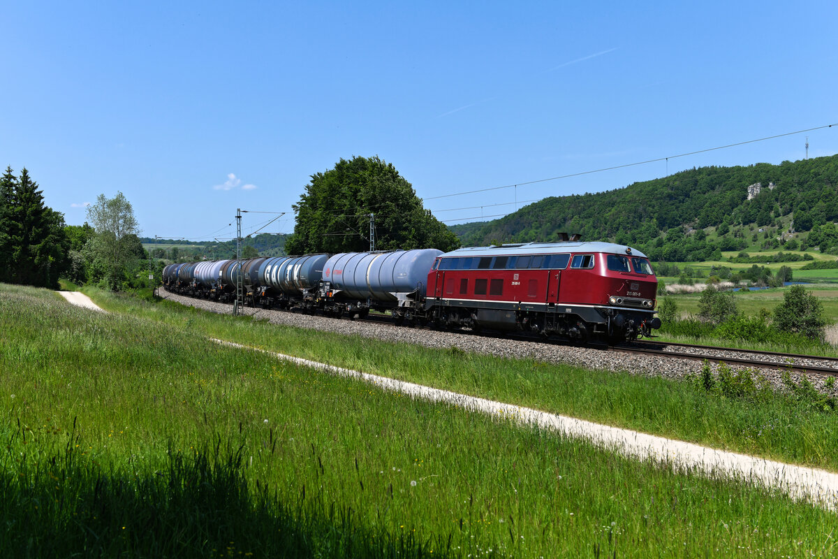 Eine ordentliche Portion Feinstaub bekam ich zur Mittagszeit des 03. Juni 2021 bei Dollnstein im Altmühltal ab, als die 215 001 der IGE mit einem Kesselwagenzug auftauchte. Der wunderschöne purpurrote Diesellok-Klassiker überraschte mich unmittelbar nach Ankunft an der Fotostelle - eine ungewöhnliche Situation, denn aufgrund der zahlreich bestehenden Sichtungsgruppen fährt heutzutage kaum eine Leistung unentdeckt durch die Lande. 