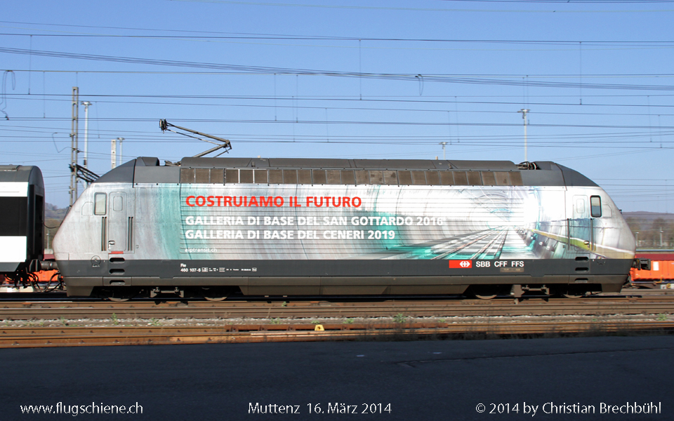 Eine weitere Werbelok der SBB ist die Re 460 107-6 für die neuen Bahntunnel welche in den nächsten Jahren eröffnet werden sollen, hier bei der Vorbeifahrt im Bhf Muttenz am 16. März 2014.