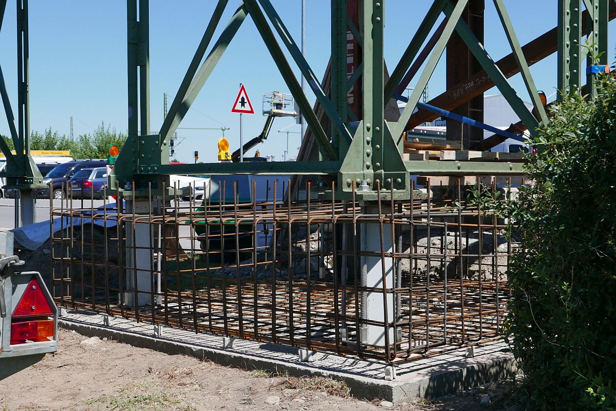 Erh�hung Fu�g�ngersteg in Biberach (Ri�) / (|V) - Da der aus dem Jahr 1909 stammende Fu�g�ngersteg �ber die Bahnlinie Ulm - Friedrichshafen zu niedrig war, um im Zuge der Elektrifizierung der S�dbahn Oberleitungen darunter durchzuf�hren, wurde der Steg um 68 cm erh�ht. Im Bild zu sehen ist das untere Ende der westlichen St�tze des Fu�g�ngersteges, an dem die Vorarbeiten zur Betonierung des erh�hten Fundaments abgeschlossen sind (04.07.2019).