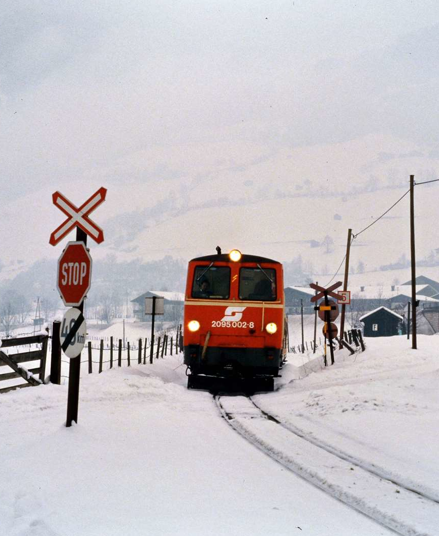 Es hatte zuvor sehr viel geschneit und ÖBB-Lok 2095.002-8 musste sich ihren Weg durch den Schnee  bahnen. Die Pinzgauer Lokalbahn war zu dieser Zeit noch ÖBB-eigen.
Datum: 11.02.1986