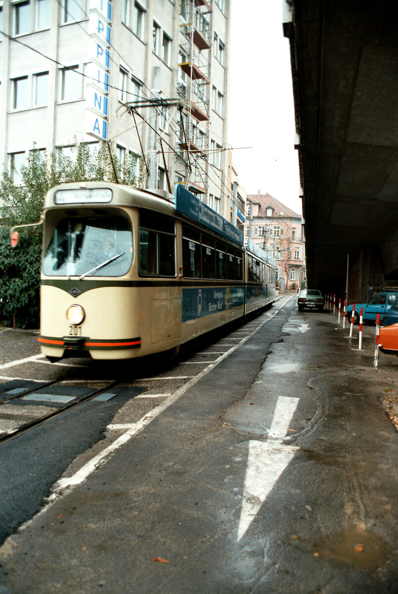 Freiburger Straßenbahn: TW 201 vom Typ GT8 unter einer Brücke auf seinem Weg zum Hauptbahnhof. 
Datum: 29.10.1983