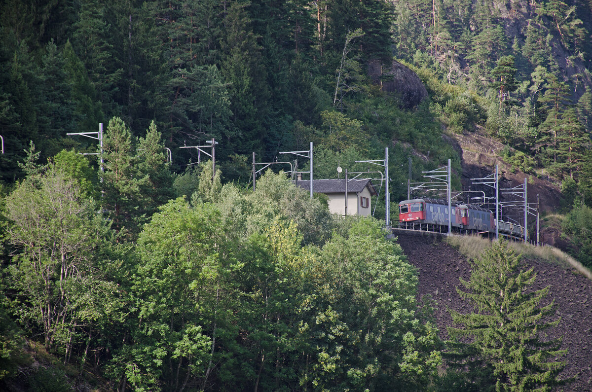 Freitag den 18.08.2023 um 16:55 Uhr. Talwärts fahrender Güterzug (Süd-Nord). Dieser Zug befördert das Ausbruchmaterial welches vom Bau der zweiten Röhre des Gotthardstrassentunnel stammt Talabwärts. Dieses Material wird nach Flüelen befördert und dort in den Vierwaldstättersee (Urnerbecken) gekippt. Als Zuglok dienen zwei Re 6/6. 1. Lok ist die Re 620 mit der Nummer 91 85 4620 022-4 CH-SBBC mit dem Wappen von Suhr. 2. Lok ist die Re 620 mit der Nummer 91 85 4620 078-6 CH-SBBC mit dem Wappen von Bassersdorf. Er kommt soeben aus dem Strahllochtunnel. Grundsatz zum heutigen Besuch an der alten Gotthard Nordrampe ist der Momentane Verkehr welcher sich durch die Vorübergehende Schliessung des Gotthard Basistunnel ergibt. Etliche Züge welche schon lange nicht mehr über die alte Bergroute verkehren erscheinen nun an der alten Gotthardrampe. Die Aufnahmen wurden zwischen Erstfeld und Göschenen gemacht. Koordinaten GMS (Grad, Minuten, Sekunden): N 46° 42’ 25.7’’ O 8° 36’ 3.1’’