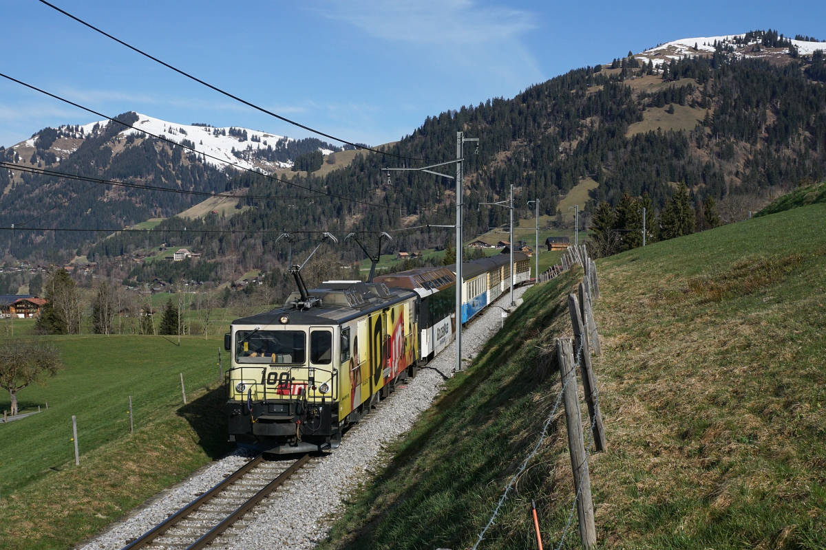 GDe 4/4 6006 rollt am 12.04.2015 mit ihrem bunt gemischten Regionalzug von Gruben Richtung Gstaad.