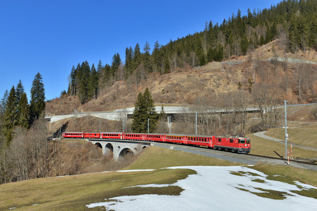 Ge 4/4 II 621 mit einem RE nach Scuol am 19.03.2016 bei Serneus. 