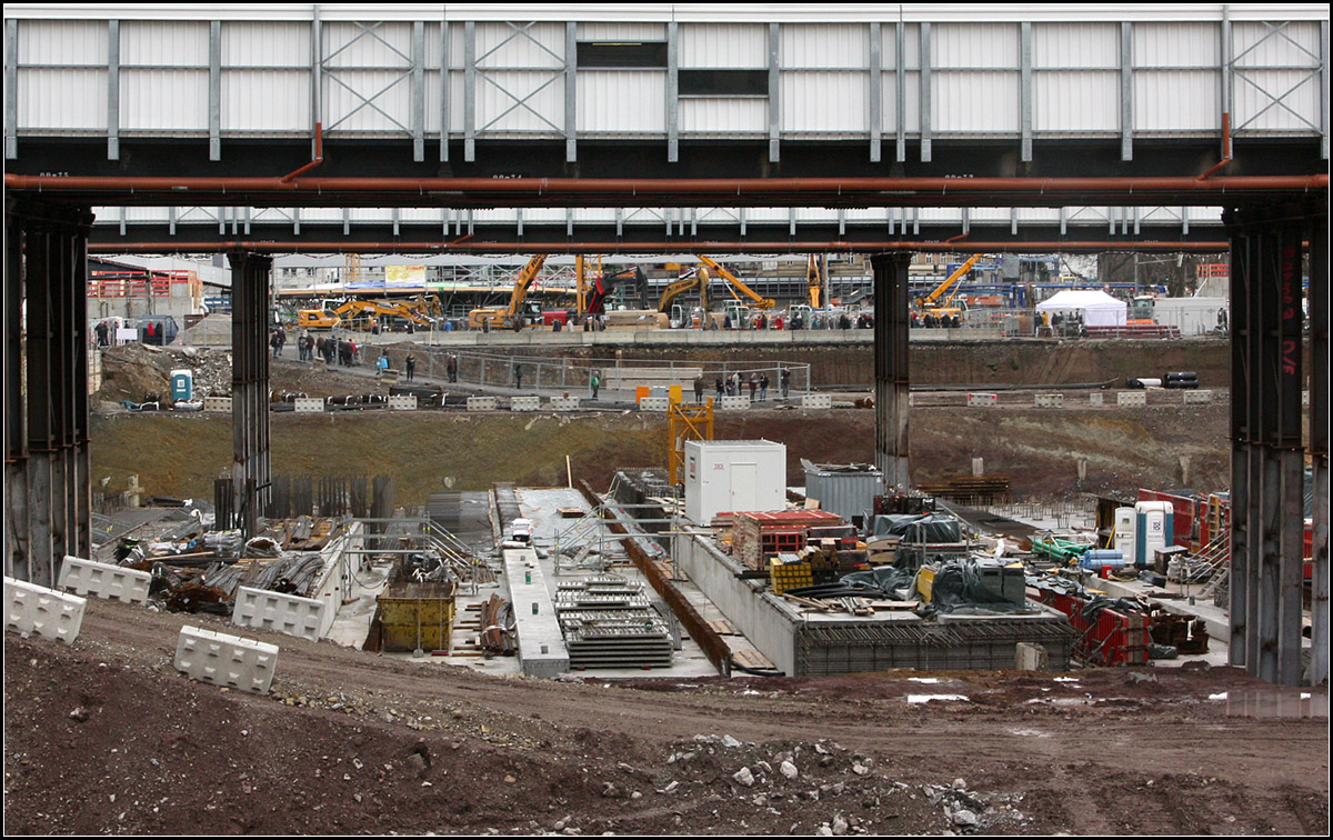 Gleiströge und Bahnsteige -

Unter den Fahrgastbrücken entsteht ein Abschnitt der zukünftigen Gleiströge und Bahnsteige. Da noch nicht über die Fluchttreppen entschieden wurde (auf den Bahnsteigen, oder an den Bahnsteigenden) müssen beide Optionen bei der Statik berücksichtigt werden. Ansonsten hätte man noch nicht mit dem Bau beginnen können.

Im Hintergrund sind die Baufahrzeuge für die Tage der offenen Baustelle aufgestellt.

05.01.2018 (M)