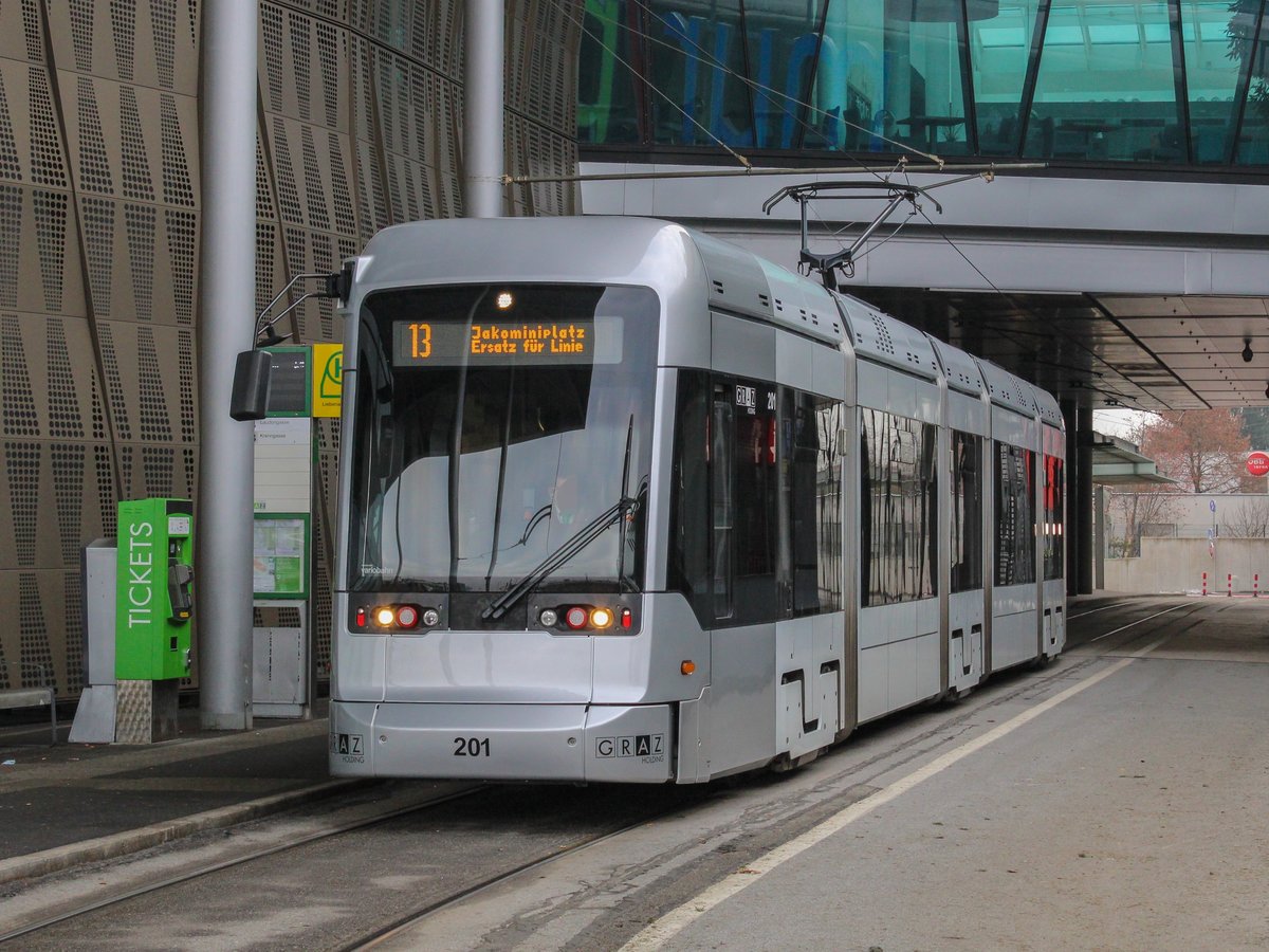 Graz. Am 13.12.2020 fanden in Graz Massentestungen auf das Coronavirus statt, dabei wurde ein Shuttleverkehr mit Einschubwagen eingerichtet.
Zwei Variobahnen waren als Linie E13 unterwegs. Das besondere daran ist, das aufgrund der Infrastruktur auf der Linie 3 und 13 im Bereich Schillerplatz keine Variobahnen auf den genannten Linien unterwegs sein können. Da die Einschübe allerdings kurzgeführt über den Jakominiplatz/Steierhof wurden, war es also doch möglich, das seltene Phänomen, eine Variobahn als  13er  zu fotografieren.
Graz Linien Variobahn 201 ist hier bei der Ankunft am Murpark zu sehen.
