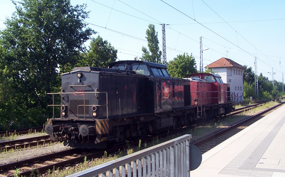 Hennigsdorf b. Berlin am 20.8.15: Zwei modernisierte DR-V100 - 203 148 (schwarz, vorn ) und 203 121 (rot)- haben einen Schotterzug gebracht und rangieren nun. 203 121 hat das Logo von BBL und die Nr. 08, während bei 203 148 das Logo des vorherigen Benutzers RT&L am Führerhaus einfach mit dem von BBL ( für BBL-Logistik GmbH) überklebt wurde- sie wird wohl noch nicht lange dazu gehören. Beide Loks sind an diesem Tag mal an den Ort ihrer Entstehung zurückgekehrt.