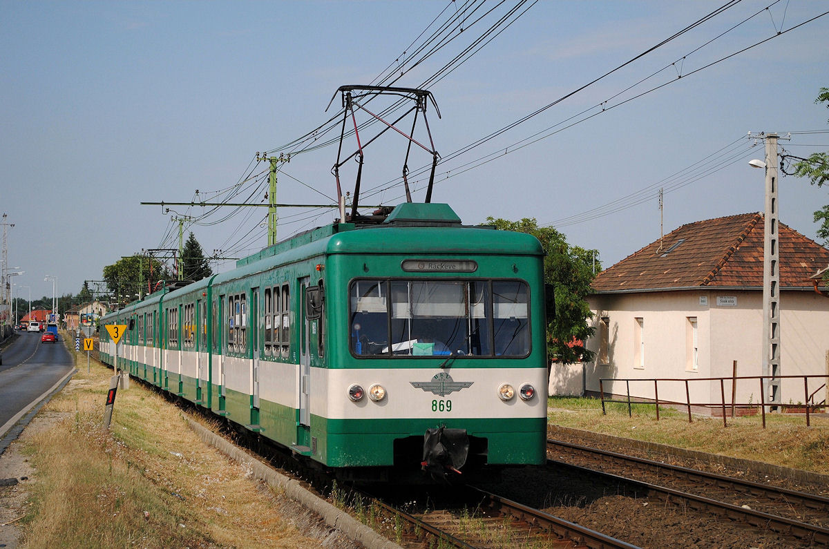 HEV -Vorortebahnzug geführt vom Tw.869 der Type MX fährt entlang der in der im Süden Budapests gelegenen Haraszti ut in Richtung Rackeve. ( 13.07.2016 ) 