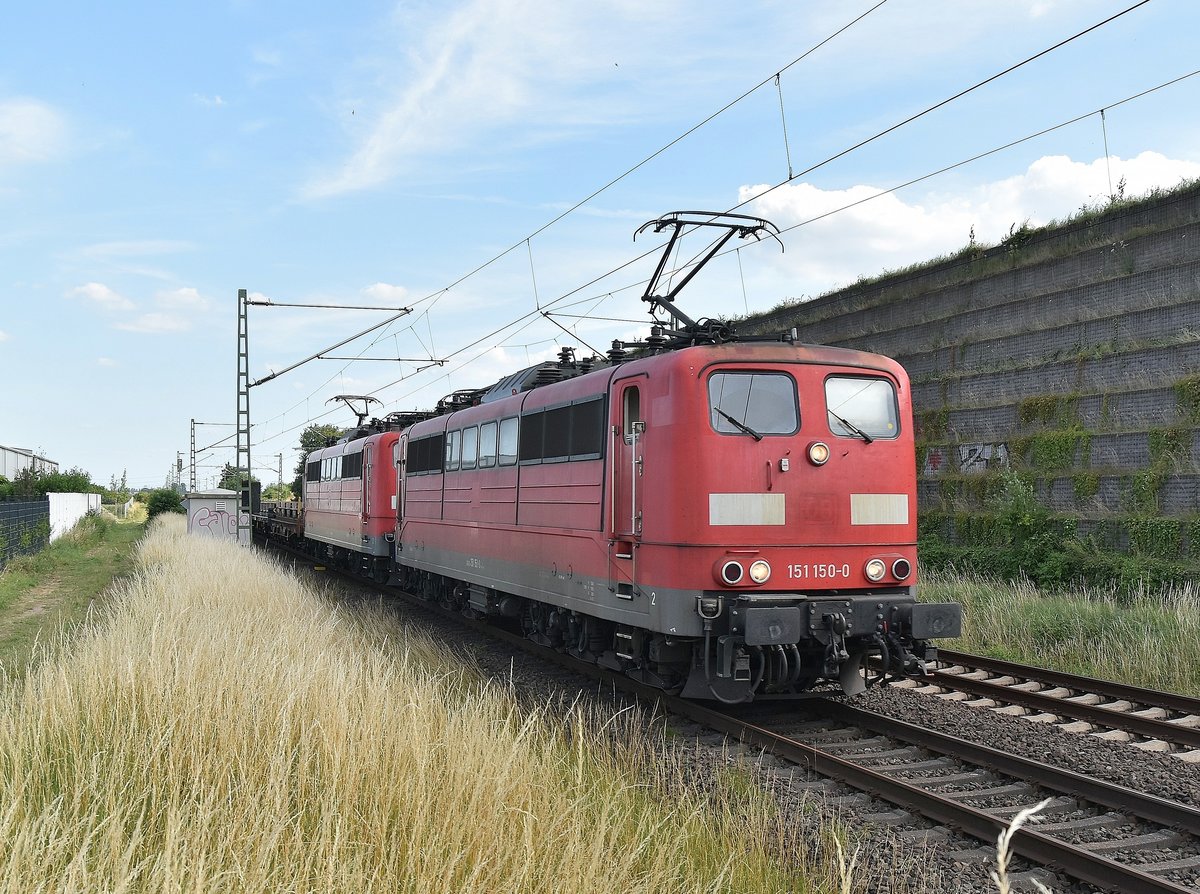 Hier kommt die 151 150-0 mit einer Schwestelok und leeren Coiltragwagen aus Nievenheim kommend durch Allerheiligen. 27.6.2018
