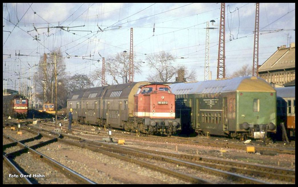 Im Gleisvorfeld des HBF Magdeburg stehen am 30.12.1990 einige Personenzuggarnituren bereit. 112327 hat einen braun beigen Dosto bespannt.