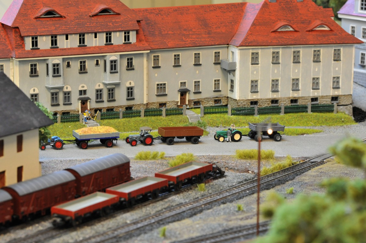 Im Hintergrund sieht man die Porzellinerhäuser. Diese waren für die Arbeiter der Porzellanfabrik bestimmt. Auf der Bahnhofsstraße warten die Bauern mit Ihren Traktoren auf die Einfahrt in das Stiftland Lagerhaus. (Bahnhofsmodell Tirschenreuth)