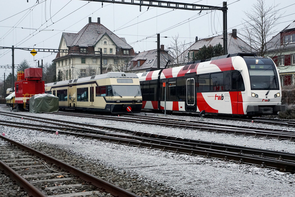 IMPRESSIONEN VOM BAHNHOF WIL
AB/FW: Hinter dem SBB befindet sich der Endbahnhof der Frauenfeld-Wil-Bahn. Dort begegnete am am trüben Morgen des 6. Dezember 2017 der ABe 4/8 7002  ZEBRA  als S l5 bei der Einfahrt FW-Dienstwagen sowie zwei abgestellten Be 2/6 7001-7004, ehemals MVR/MOB, die auf die Aufarbeitung bei Stadler Rail warten.
Ihre neue Heimat für weitere zehn Jahre ist bei der ASm das Seeland und der Oberaargau.
Fotostandort hinter der Abschrankung. Bildausschnitt Fotoshop.
Foto: Walter Ruetsch