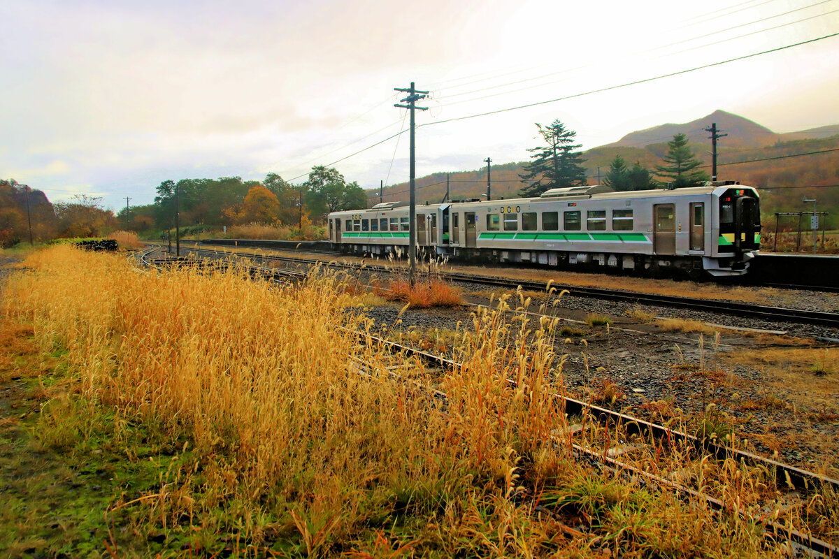 In den ersten Sonnenstrahlen stehen die Triebwagen H100-12 und H100-5 in Shikaribetsu an der alten Hakodate Hauptstrecke über den Pass von Kutchan. 29.Oktober 2022 